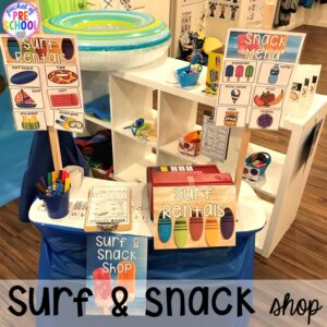 Pretend snack and surf shop! Set up a Beach in the dramatic play or pretend center and embed a ton of math, literacy, and STEM into their play! #dramaticplay #pretendplay #preschool #prek #beachtheme #oceantheme